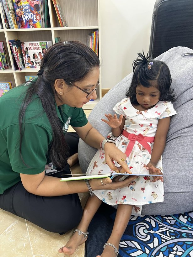 A teacher reading with a young learner